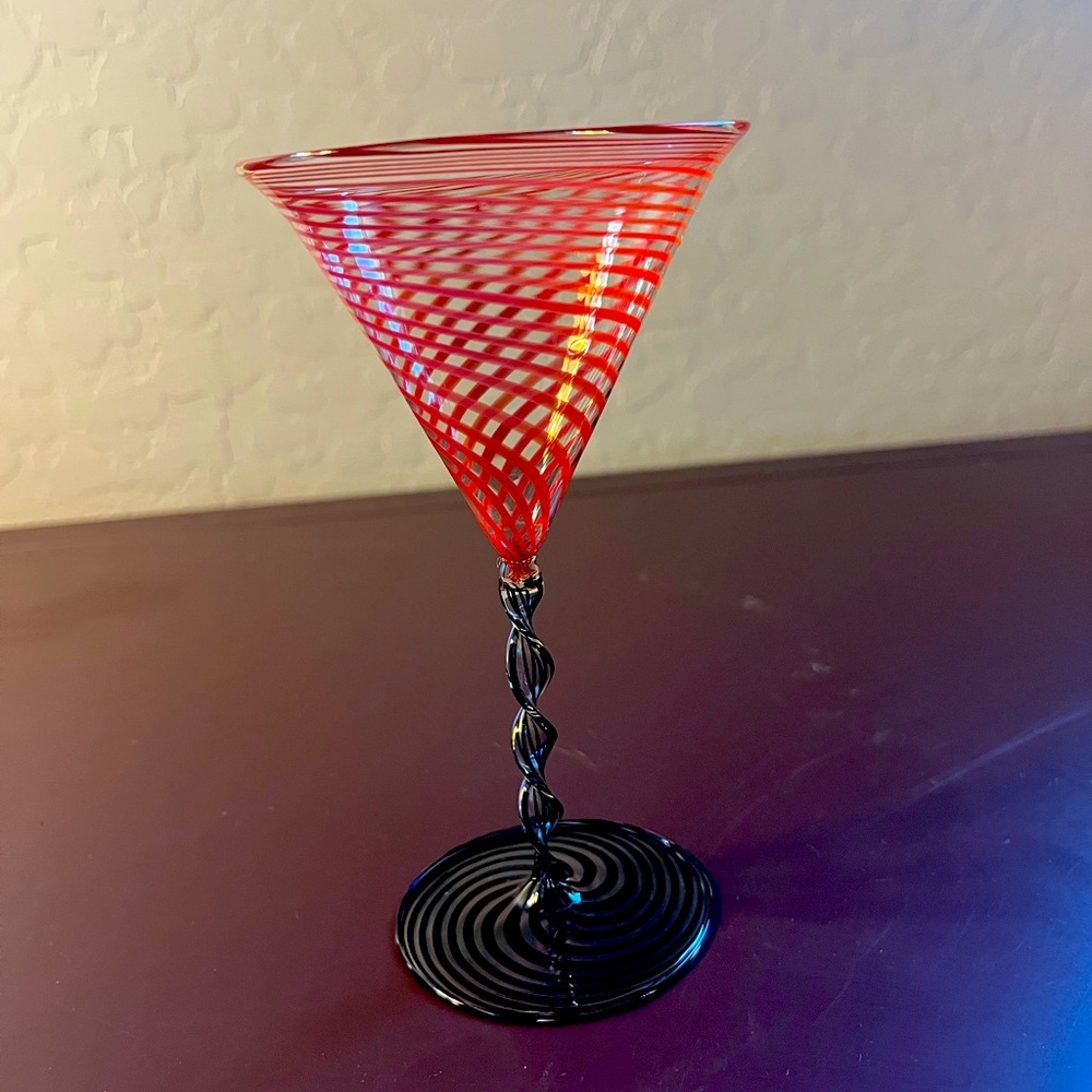 Shaken not stirred.  Orange stripes and black swirls, hand blown Martini Glass